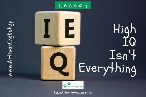 Two wooden blocks stacked on top of one another. On the top one there is an I on one side and an E on the other. On the bottom block there is a Q.